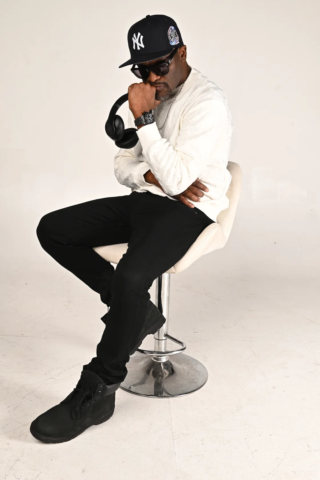 Glenn Toby in a white shirt, seated with headphones